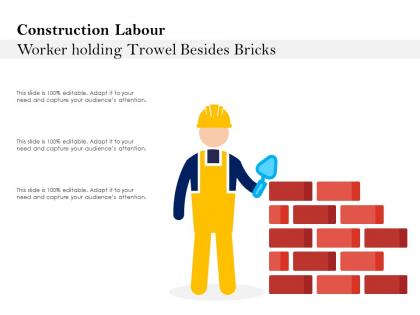 Construction labour worker holding trowel besides bricks