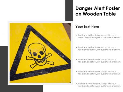 Danger alert poster on wooden table
