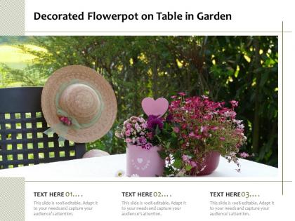 Decorated flowerpot on table in garden