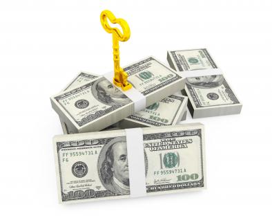Dollar bundles with golden key on white background stock photo