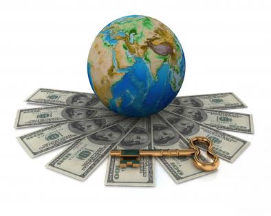 Earth globe with multiple dollars around stock photo