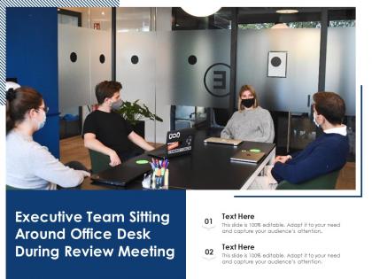 Executive team sitting around office desk during review meeting