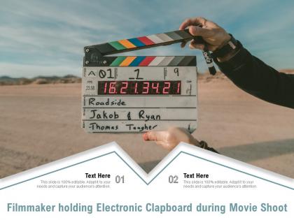 Filmmaker holding electronic clapboard during movie shoot