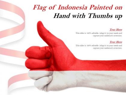Flag of indonesia painted on hand with thumbs