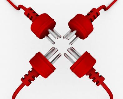 Four plugs in red color facing each other in technology stock photo