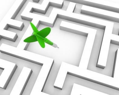 Green dart in middle of the maze for business target stock photo