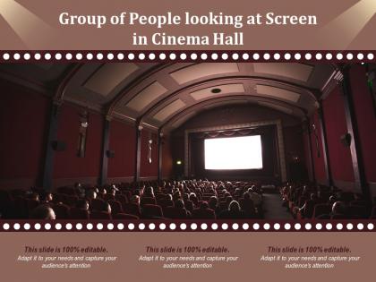 Group of people looking at screen in cinema hall