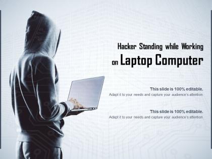 Hacker standing while working on laptop computer