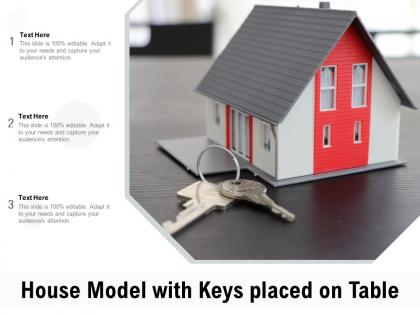 House model with keys placed on table