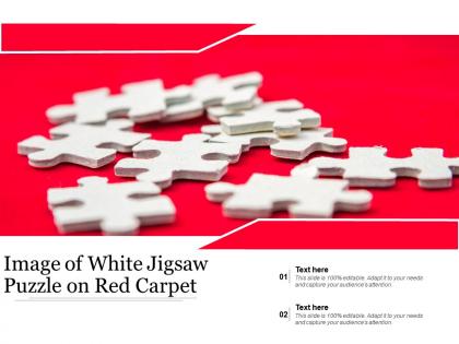 Image of white jigsaw puzzle on red carpet