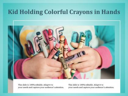 Kid holding colorful crayons in hands