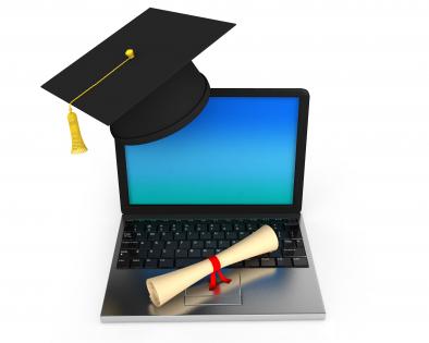 Laptop for learning and graduation cap with degree stock photo