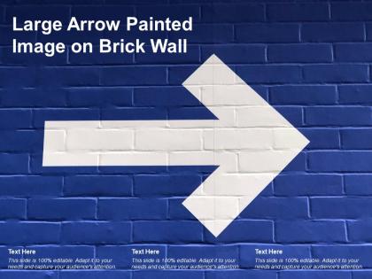 Large arrow painted image on brick wall