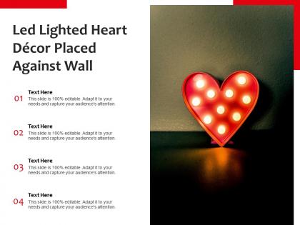 Led lighted heart decor placed against wall