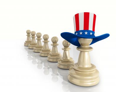 Linear orders of chess pawns with one leading and wearing us flag hat stock photo