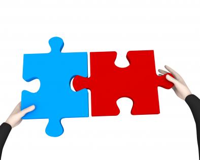 Man fixing red and blue puzzle to display problem solving stock photo