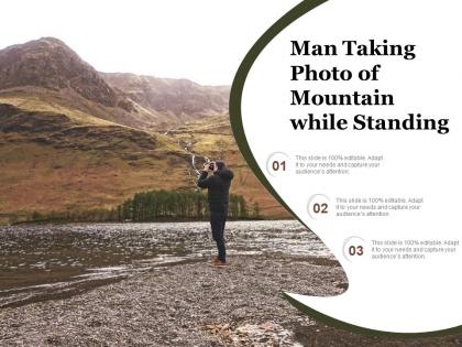 Man taking photo of mountain while standing