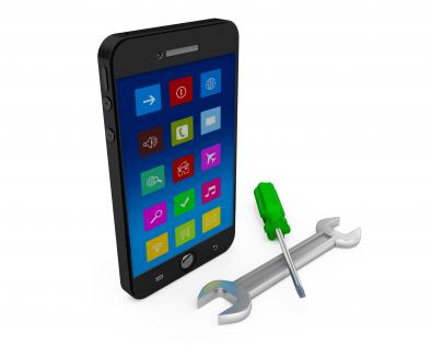 Mobile phone with wrench and screwdriver showing tools and service stock photo