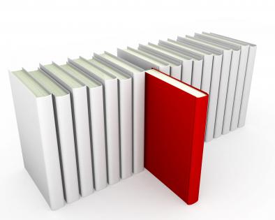 Multiple books in line with red book coming out as leader stock photo
