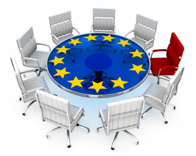 Multiple silver chairs with red chair as leader and european symbol stock photo