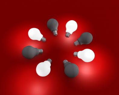 On and off light bulbs on red background stock photo