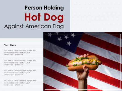 Person holding hot dog against american flag