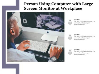 Person using computer with large screen monitor at workplace