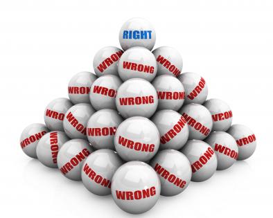 Pyramid of wrong balls with right ball on top stock photo