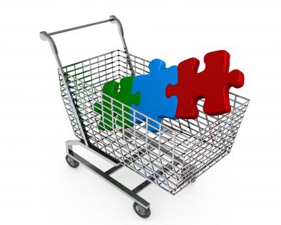 Red blue green puzzle in shopping cart showing marketing stock photo
