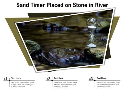 Sand timer placed on stone in river