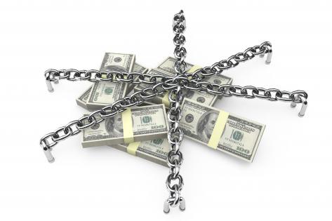 Silver chains and lock on dollars stock photo