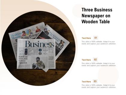 Three business newspaper on wooden table