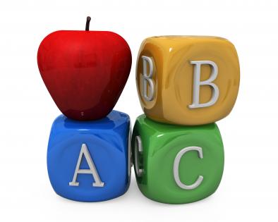 Three cubes of abc letters with apple stock photo