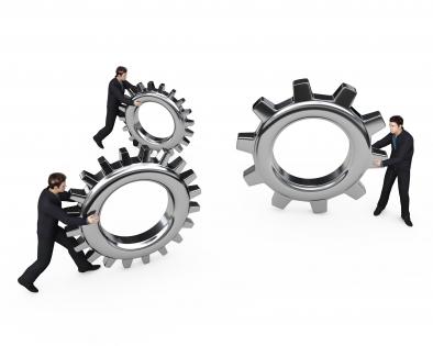 Three man holding gears shows business innovation creative idea stock photo