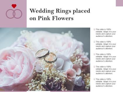 Wedding rings placed on pink flowers