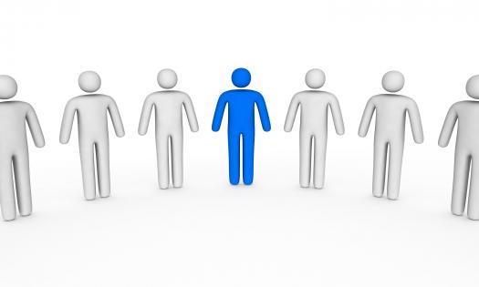 White 3d men icons with blue man as a leader stock photo