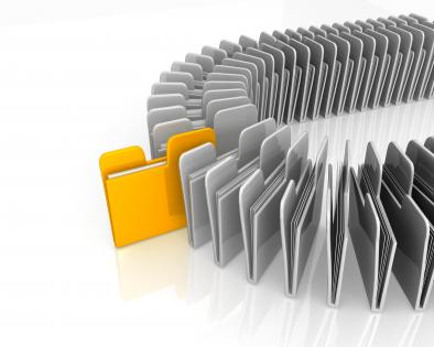 White computer folders with one yellow folder standing out stock photo