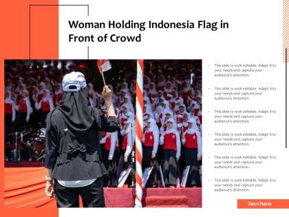 Woman holding indonesia flag in front of crowd