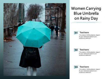 Women carrying blue umbrella on rainy day