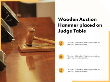 Wooden auction hammer placed on judge table