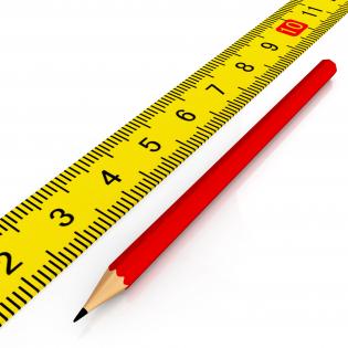 Yellow scale with red pencil for engineering stock photo